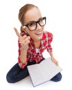 Smiling teenage girl in eyeglasses reading book Royalty Free Stock Photo