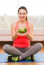 Smiling teenage girl with green salad at home Royalty Free Stock Photo