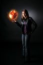 Smiling teenage girl holding orange fireball