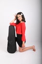 Smiling teenage girl kneeling with violin case Royalty Free Stock Photo