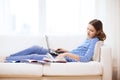 Smiling teenage girl with laptop computer at home Royalty Free Stock Photo