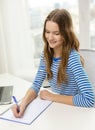 Smiling teenage girl laptop computer and notebook Royalty Free Stock Photo