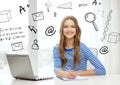 Smiling teenage girl laptop computer and notebook Royalty Free Stock Photo