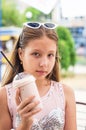 Smiling teenage girl with milkshake on summer day Royalty Free Stock Photo