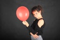 Smiling teenage schoolgirl with red baloon