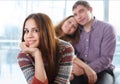 Smiling teenage girl sitting in front of her parents Royalty Free Stock Photo