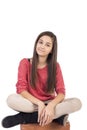 Smiling teenage girl sitting on with legs crossed Royalty Free Stock Photo