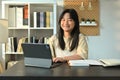 Smiling teenage girl studying online classes on digital tablet at home. Online learning, homeschooling concept Royalty Free Stock Photo