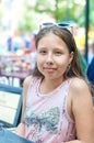 Smiling teenage girl in sunglasses in cafe on summer day Royalty Free Stock Photo