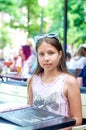 Smiling teenage girl in sunglasses in cafe on summer day Royalty Free Stock Photo