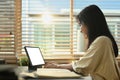 Smiling teenage girl using digital tablet, studying remotely at home. Homeschooling, online education, e-learning Royalty Free Stock Photo