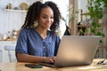 Smiling teenage girl using laptop computer at home. Royalty Free Stock Photo