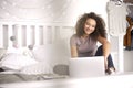 Teenage girl using a laptop in her bedroom Royalty Free Stock Photo