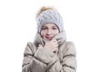 Smiling teenage girl in a warm jacket and a knitted hat with a fluffy pompom. Warmth and comfort in the cold season. Isolated on Royalty Free Stock Photo