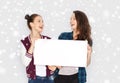 Smiling teenage girls holding white blank board Royalty Free Stock Photo