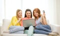 Smiling teenage girls with laptop and credit card Royalty Free Stock Photo