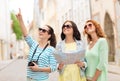 Smiling teenage girls with map and camera Royalty Free Stock Photo