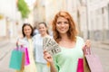 Smiling teenage girls with shopping bags on street Royalty Free Stock Photo