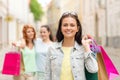 Smiling teenage girls with shopping bags on street Royalty Free Stock Photo