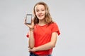 Smiling teenage showing smartphone