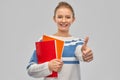 Smiling teenage student girl showing thumbs up Royalty Free Stock Photo