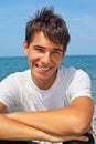 Smiling teenager boy against sea Royalty Free Stock Photo