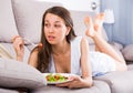 Smiling teenager is enjoying tasty green salad