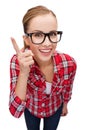 Smiling teenager in eyeglasses with finger up Royalty Free Stock Photo