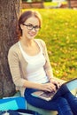 Smiling teenager in eyeglasses with laptop Royalty Free Stock Photo