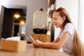 Smiling teenager feeling relaxed while sitting in cafe