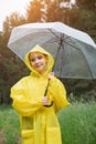 Smiling girl stands against forest holding stylish umbrella Royalty Free Stock Photo