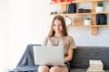 Smiling teenager girl studying using her laptop at home Royalty Free Stock Photo