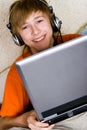 Smiling teenager with a laptop Royalty Free Stock Photo