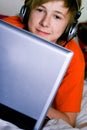 Smiling teenager with a laptop Royalty Free Stock Photo