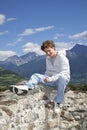 Smiling teenager sitting on a wall