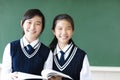 Smiling teenager student girls in classroom Royalty Free Stock Photo