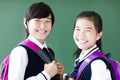 Smiling teenager student girls in classroom Royalty Free Stock Photo