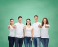 Smiling teenagers in t-shirts showing thumbs up Royalty Free Stock Photo