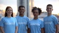 Smiling teens volunteers sincerely smiling on camera, international help project Royalty Free Stock Photo