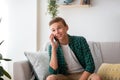 Smiling ten guy talking on phone, sitting at home Royalty Free Stock Photo