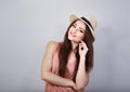 Smiling thinking happy woman in pink t-shirt and suumer straw hat on blue background