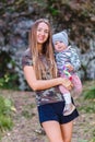 Smiling thirty-year-old woman holding one-year-old girl in her arms Royalty Free Stock Photo