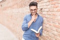 Smiling and thoughtful casual man reading a book