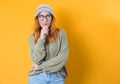 Smiling thoughts young woman thinking. Close up portrait of inspired girl with smile face expression, isolated on yellow Royalty Free Stock Photo