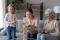 Happy three generations of women play wooden game