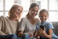 Happy three generations of women use smartphone gadget Royalty Free Stock Photo