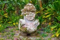 Smiling tiki. Carved stone Polynesian sacred idol statue. Raivavae island, Astral islands, French Polynesia, Oceania.