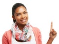 Smiling to endorse your brand. Young woman pointing upwards against a white background.