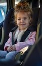 Smiling toddler girl buckled into her car seat Royalty Free Stock Photo