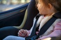 Smiling girl sitting in the car seat -Safety and security close